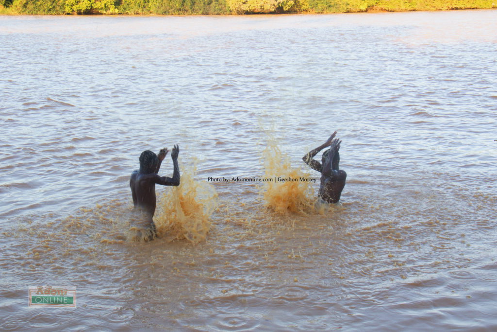 Two boys take a swim in River Pra at Borkokope in the Shaman District, Western Region | Adomonline.com