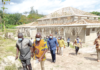 Mr Alexander Frimpong (left), District Chief Executive for Asante Akim, with Nii Lantey Vanderpuiye after inspecting work on a court complex in the municipality