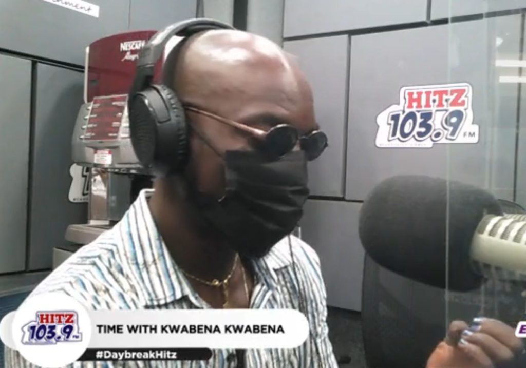 Kwabena Kwabena takes a look at his blue painted fingernails in the Hitz FM studio during interview with Andy Dosty