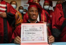 Didier Drogba poses for a photograph after receiving an Honorary degree from the University of Sciences and Technology of Africa network (RUSTA) in Abidjan