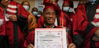 Didier Drogba poses for a photograph after receiving an Honorary degree from the University of Sciences and Technology of Africa network (RUSTA) in Abidjan