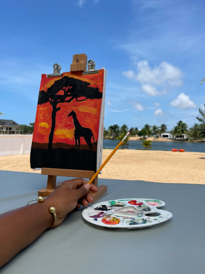 Yvonne Nelson paints giraffe and a tree at YN Island, Ada | Adomonline.com