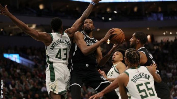 Reigning champions Milwaukee Bucks started their title defence with victory over Brooklyn Nets