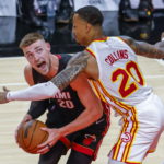 Miami Heat forward Micah Potter (L) in action against Atlanta Hawks forward John Collins (R) during the first half of the preseason NBA basketball game between the Miami Heat and the Atlanta Hawks at State Farm Arena in Atlanta, Georgia, USA, 14 October 2021. EPA/ERIK S. LESSER SHUTTERSTOCK OUT