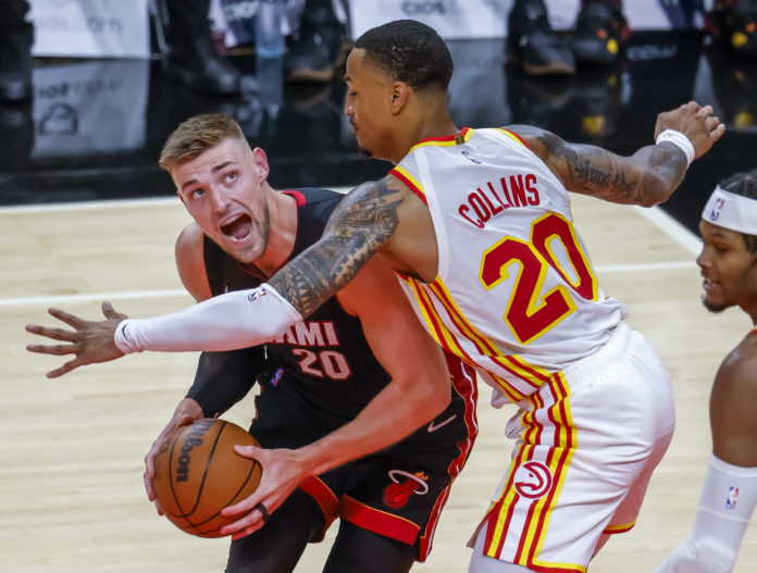 Miami Heat forward Micah Potter (L) in action against Atlanta Hawks forward John Collins (R) during the first half of the preseason NBA basketball game between the Miami Heat and the Atlanta Hawks at State Farm Arena in Atlanta, Georgia, USA, 14 October 2021. EPA/ERIK S. LESSER SHUTTERSTOCK OUT