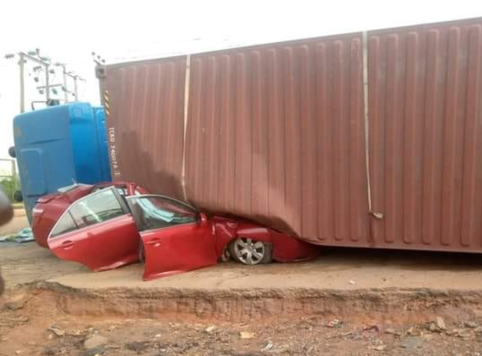 Occupants escape unhurt as container falls on vehicle