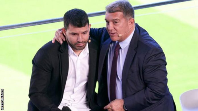 Aguero was consoled by Barcelona president Joan Laporta during the news conference