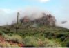 In this Jan. 29, 2015, file photo, low-hanging winter clouds hug part of Superstition Mountain in Lost Dutchman State Park in Apache Junction, Ariz.