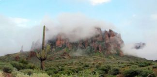 In this Jan. 29, 2015, file photo, low-hanging winter clouds hug part of Superstition Mountain in Lost Dutchman State Park in Apache Junction, Ariz.