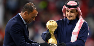 AL KHOR, QATAR - DECEMBER 18: Former Saudi Arabian International Player, Nawaf Al-Temyat (R) and Former Brazilian World Cup Winner, Cafu (L) place the FIFA Arab Cup Trophy on a plinth on pitch following the FIFA Arab Cup Qatar 2021 Final match between Tunisia and Algeria at Al Bayt Stadium on December 18, 2021 in Al Khor, Qatar. (Photo by Michael Regan - FIFA/FIFA via Getty Images)