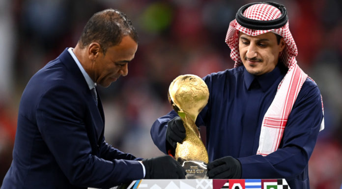 AL KHOR, QATAR - DECEMBER 18: Former Saudi Arabian International Player, Nawaf Al-Temyat (R) and Former Brazilian World Cup Winner, Cafu (L) place the FIFA Arab Cup Trophy on a plinth on pitch following the FIFA Arab Cup Qatar 2021 Final match between Tunisia and Algeria at Al Bayt Stadium on December 18, 2021 in Al Khor, Qatar. (Photo by Michael Regan - FIFA/FIFA via Getty Images)