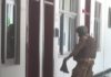 A prison officer holding the boots of the injured colleague