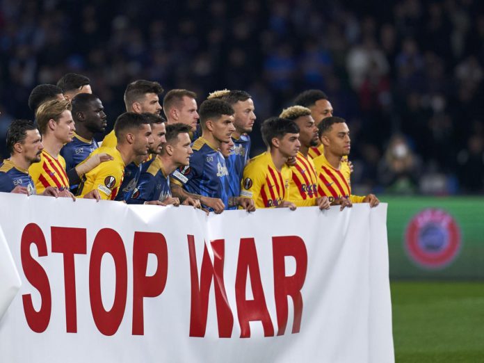 Barcelona and Napoli players hold banner