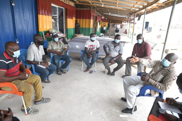 Mr Emmanuel K.E. Appoh (right), acting Director of Environmental Quality of the EPA, addressing the executive of the Korle Bu Coffin Makers Association. Picture: Emmanuel Quaye