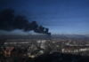 Black smoke rises from a military airport in Chuguyev near Kharkiv on February 24, 2022 [Aris Messinis/AFP]