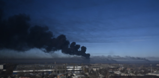 Black smoke rises from a military airport in Chuguyev near Kharkiv on February 24, 2022 [Aris Messinis/AFP]