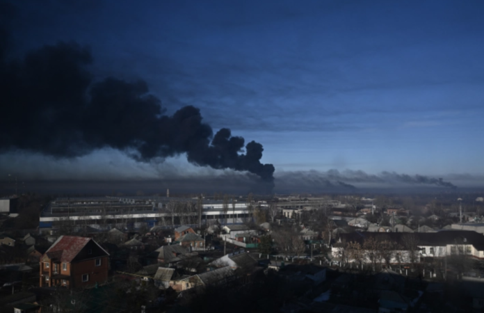 Black smoke rises from a military airport in Chuguyev near Kharkiv on February 24, 2022 [Aris Messinis/AFP]