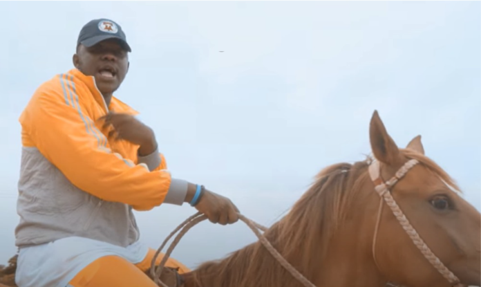 Medikal rides a horse in his 