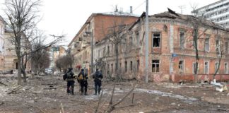 Ukrainian police officers patrol a street following shelling in Ukraine's second-biggest city of Kharkiv (Image: AFP via Getty Images)