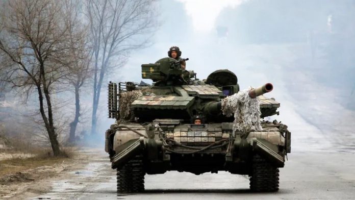 Ukrainian servicemen ride on tanks toward the front line with Russian forces in the Luhansk region of Ukraine on Friday. The president has waived entry visa requirements for any foreigners who want to join the fight against Russia. (Anatolii Stepanov/AFP via Getty Images)