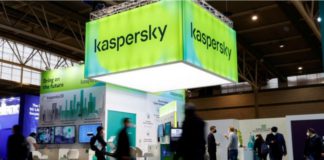 People walk next to Russian Kaspersky stand during the GSMA's 2022 Mobile World Congress (MWC), in Barcelona, Spain, March 2, 2022. REUTERS/ Albert Gea/File Photo