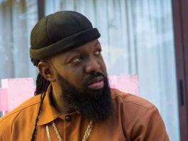 Timaya falls on stage while trying to lift plus-sized woman during performance