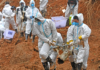 Rescuers carry a piece of plane wreckage at the site of the March 21 crash in southern China's Guangxi province. (Zhou Hua/AP)