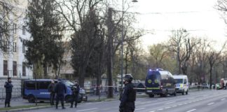 Police officers stand guard of the crime scene in Bucharest, Romania, outside the Russian embassy ( Image: REUTERS)