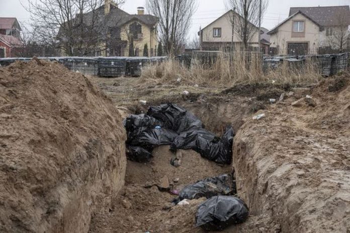 Bodies of civilians are seen in mass graves in Bucha ( Image: Anadolu Agency via Getty Images)