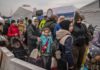 Ukrainian evacuees queue as they wait for further transport at the Medyka border crossing after they crossed the Ukrainian-Polish border ( Image: AFP via Getty Images)