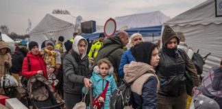 Ukrainian evacuees queue as they wait for further transport at the Medyka border crossing after they crossed the Ukrainian-Polish border ( Image: AFP via Getty Images)