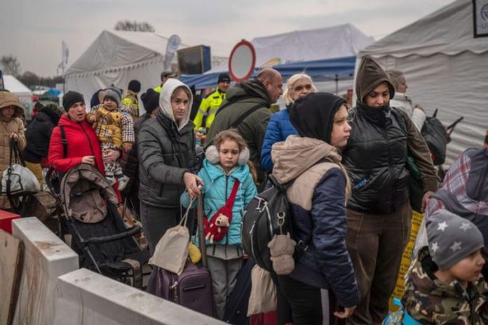 Ukrainian evacuees queue as they wait for further transport at the Medyka border crossing after they crossed the Ukrainian-Polish border ( Image: AFP via Getty Images)