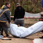 Mass grave of 132 bodies found in ditch near petrol station of Ukraine village Police members carry the body of a civilian, after they exhumed him along with another body from a well at the fuel station in Buzova (Image: REUTERS)
