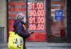 A woman walks past a currency exchange office in central Moscow on Feb. 24. Alexander Nemenov/AFP via Getty Images
