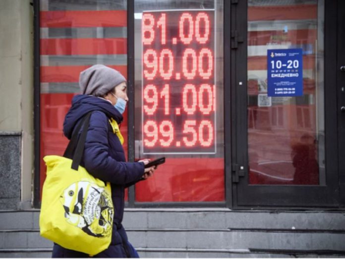 A woman walks past a currency exchange office in central Moscow on Feb. 24. Alexander Nemenov/AFP via Getty Images