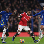 Manchester United's Fred (C) in action against Chelsea players Trevoh Chalobah (L) and Ruben Loftus-Cheek (R)