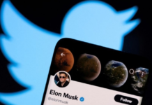 Elon Musk's twitter account is seen on a smartphone in front of the Twitter logo in this photo illustration taken, April 15, 2022. REUTERS/Dado Ruvic/Illustration/File Photo