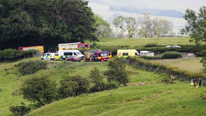 Emergency services by Bentham Road near Burton in Lonsdale, where a helicopter has crashed into a field (Image: Ben Lack Photography Ltd)