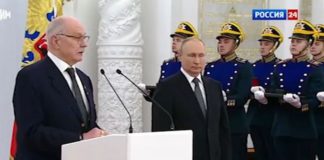 Putin stands to one side as he shakes uncontrollably ( Image: Russia-1)