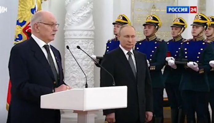 Putin stands to one side as he shakes uncontrollably ( Image: Russia-1)