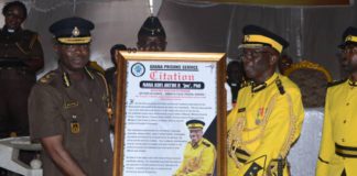 Director General of Prisons Mr. Isaac Kofi Egyir (left) presenting the citation to Nana Dr. Kofi Antwi II (right)