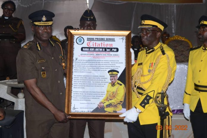 Director General of Prisons Mr. Isaac Kofi Egyir (left) presenting the citation to Nana Dr. Kofi Antwi II (right)