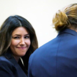 Attorney Camille Vasquez and actor Johnny Depp listen during actor's defamation case against ex-wife, actor Amber Heard, in the courtroom at the Fairfax County Circuit Courthouse in Fairfax, U.S., May 23, 2022. Steve Helber/Pool via REUTERS