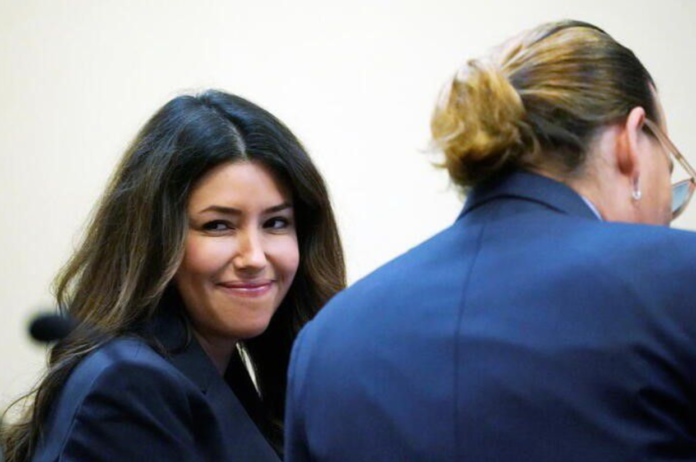 Attorney Camille Vasquez and actor Johnny Depp listen during actor's defamation case against ex-wife, actor Amber Heard, in the courtroom at the Fairfax County Circuit Courthouse in Fairfax, U.S., May 23, 2022. Steve Helber/Pool via REUTERS