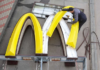 A worker dismantles the McDonald's Golden Arches logo at a drive-through restaurant in Kingisepp, Russia.