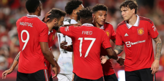 Jadon Sancho celebrates with his team-mates after scoring their first goal against Liverpool