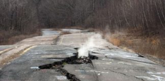 Smoke rises from a large crack in Route 61 caused by the ongoing underground fire in Centralia, Pennsylvania (Image: Don Emmert/AFP via Getty Images)