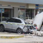 A vehicle smashed by the falling façade of a department store ( Image: REUTERS)
