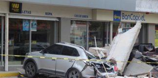 A vehicle smashed by the falling façade of a department store ( Image: REUTERS)