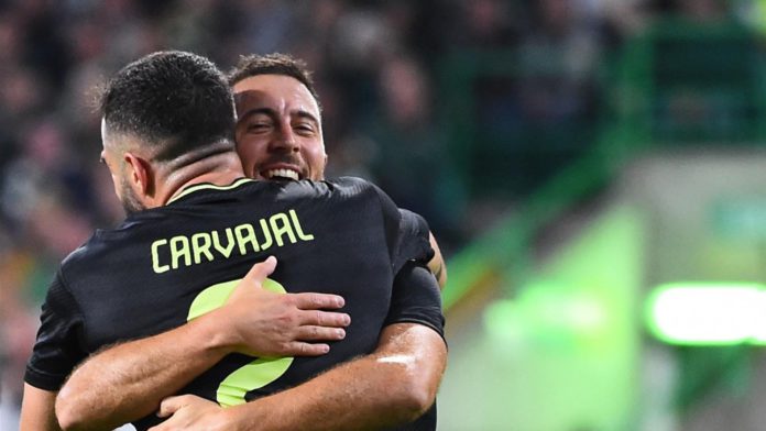 Real Madrid's Belgian forward Eden Hazard (rear R) celebrates with Real Madrid's Spanish defender Dani Carvajal after scoring his team third goal during the UEFA Champions League Group F football match between Celtic and Real Madrid, at the Celtic Park st Image credit: Getty Images